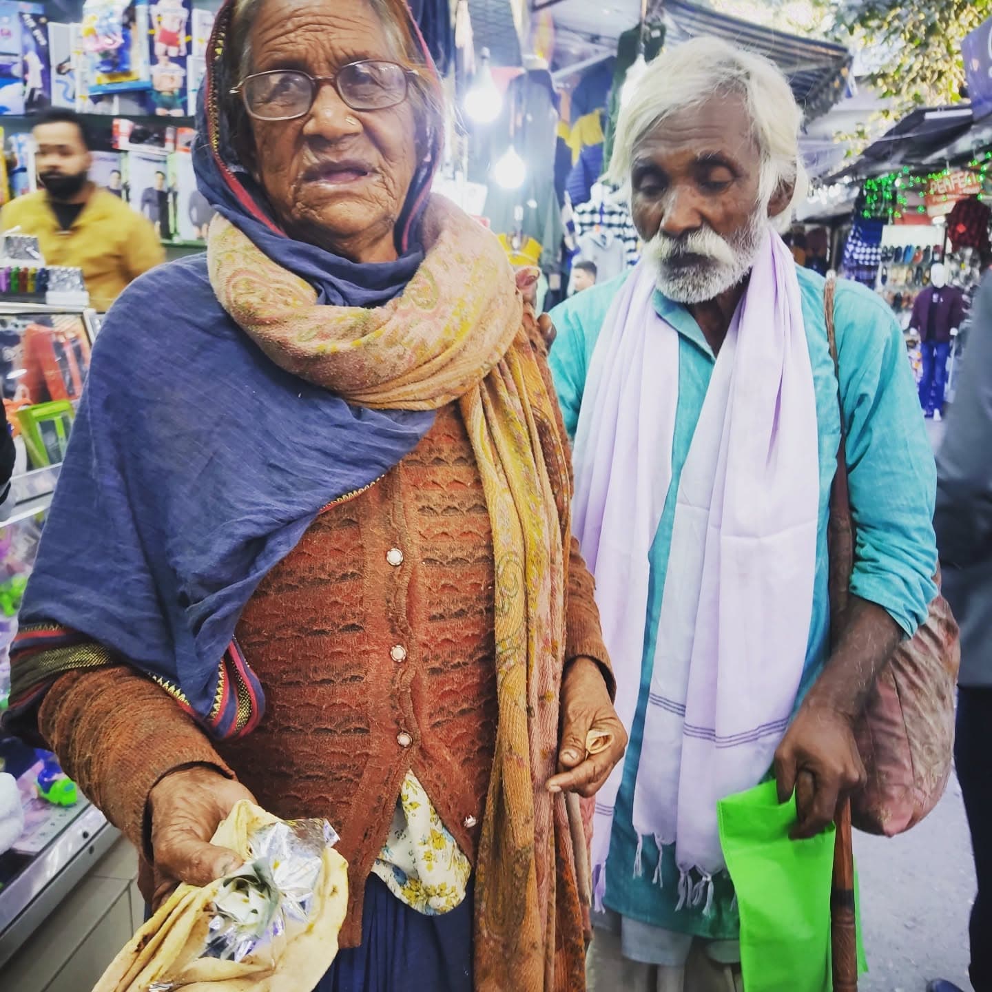 A volunteer handing a food parcel to a child